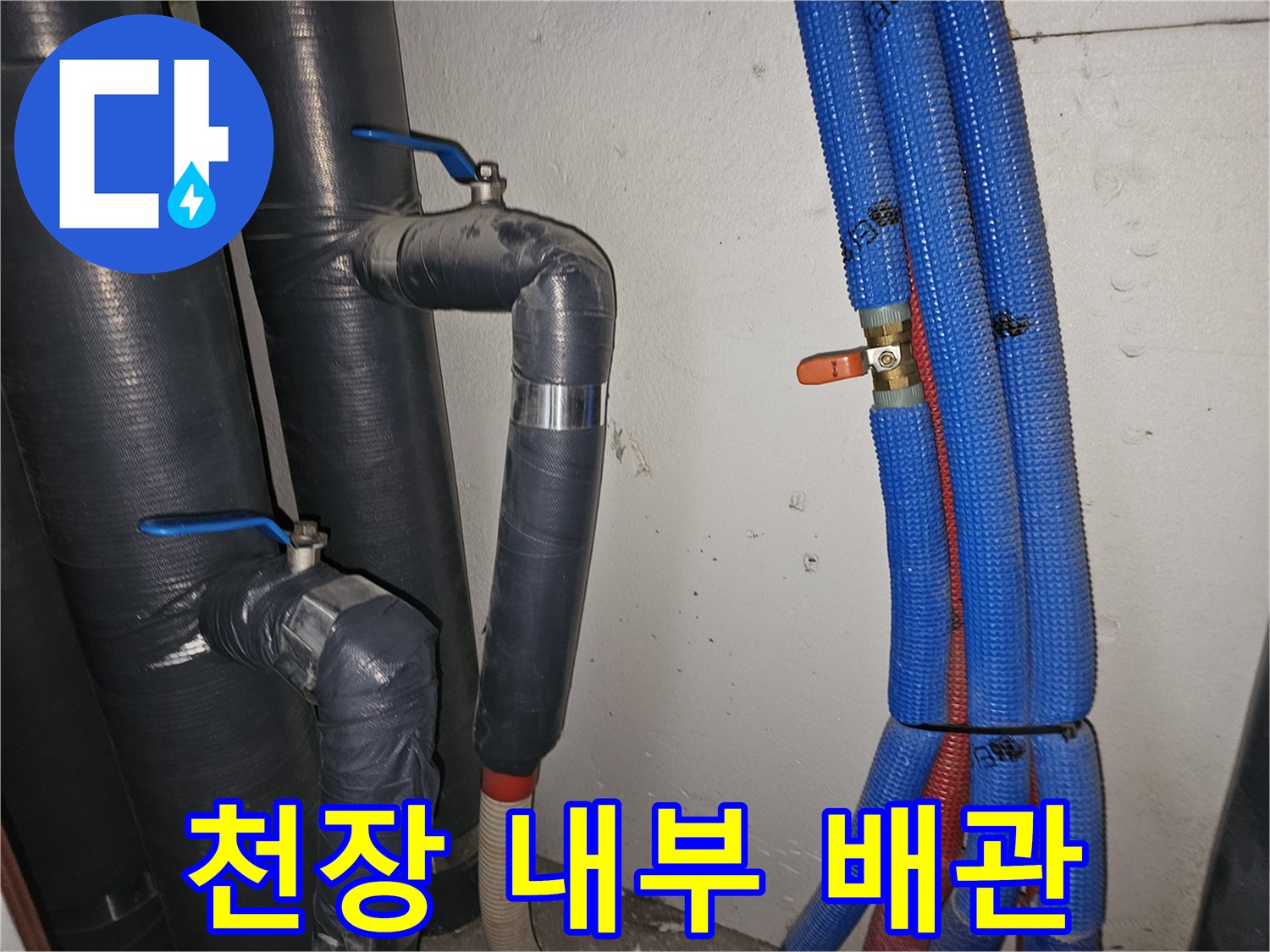 천장 점검구 안쪽의 밸브와 보온재 처리된 배관