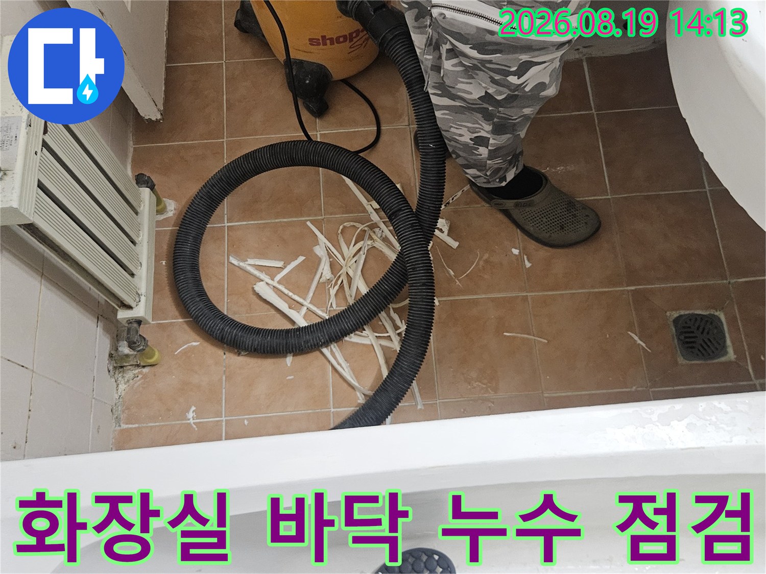 배수구 주변 타일 틈새와 유가 부근의 누수 상태를 면밀히 점검하고 있습니다.