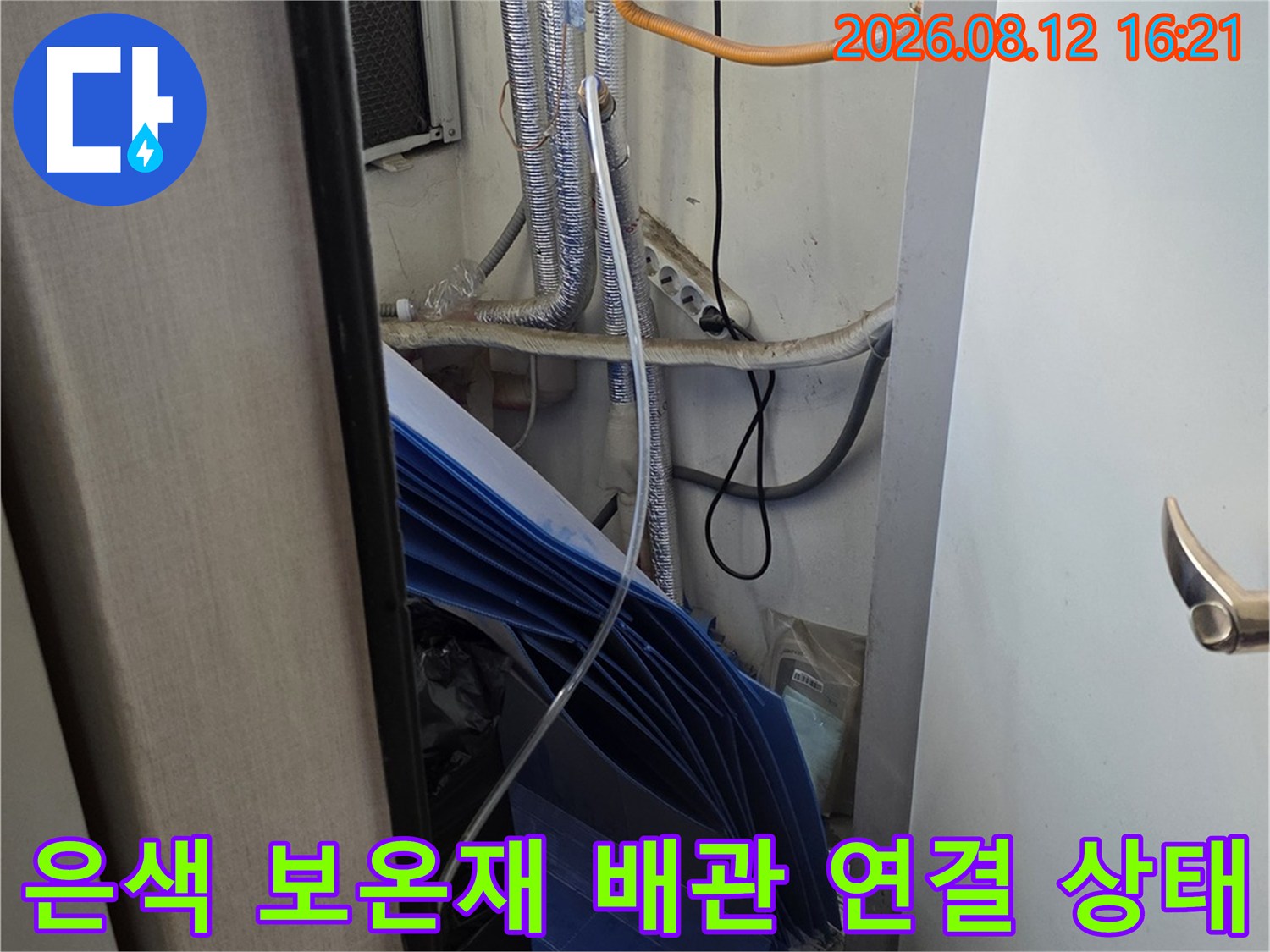 보일러 아래쪽에 설치된 은색 보온재 마감 배관-노란색 전선 배치