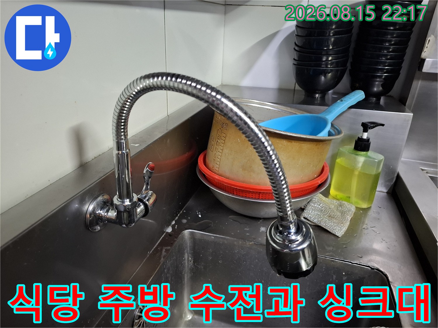 스테인리스 싱크대와 유연한 수전이 있는 식당 내부의 모습