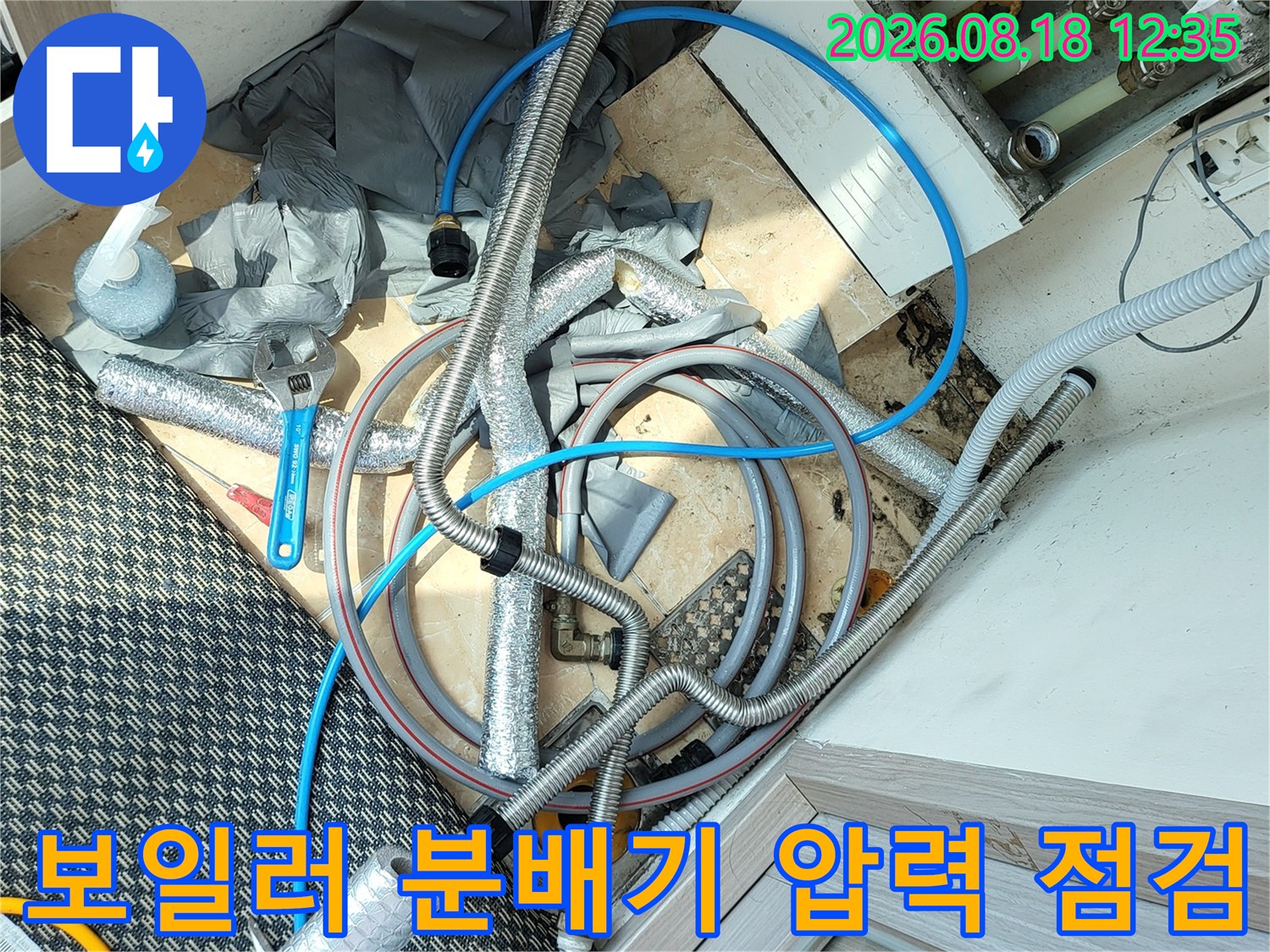 분배기와 연결된 파란색 호스와 압력 측정 장비입니다