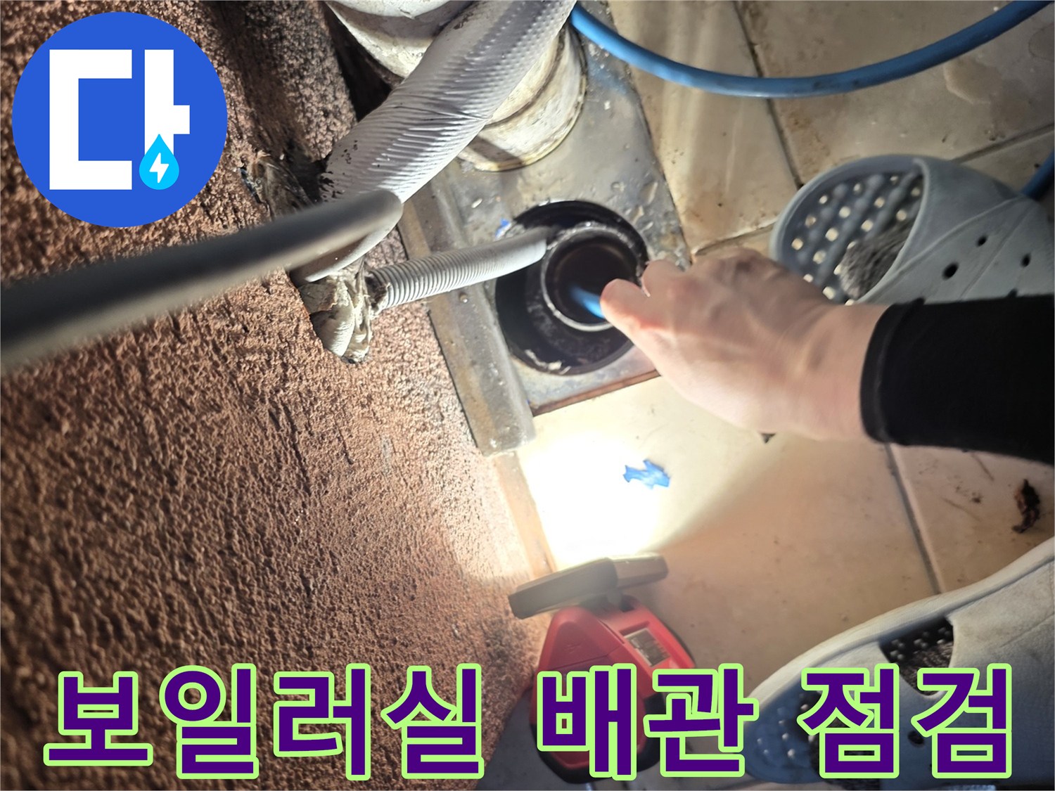보일러-하단-배관-연결부의-상태를-조사하는-엔지니어의-손길