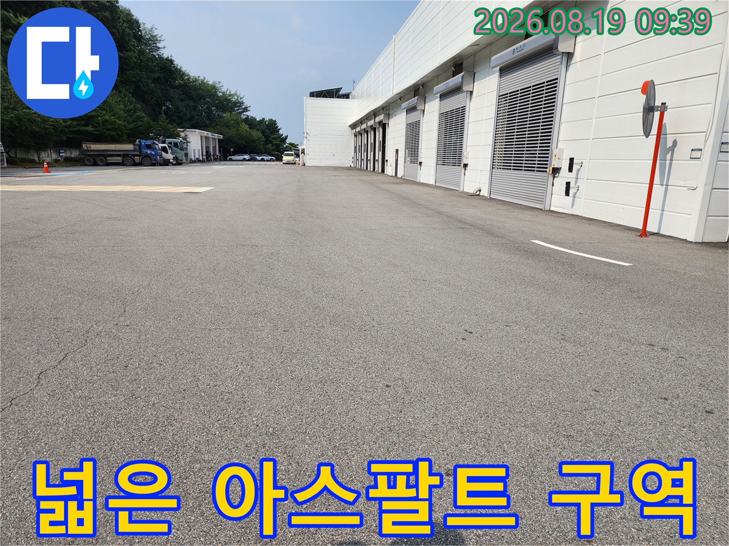 점검이 필요한 넓은 범위의 아스팔트 도로와 건물 외곽입니다.