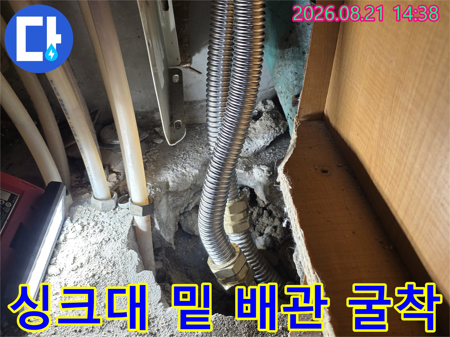 싱크대 아래쪽을 파내어 노출시킨 주름관과 배관들