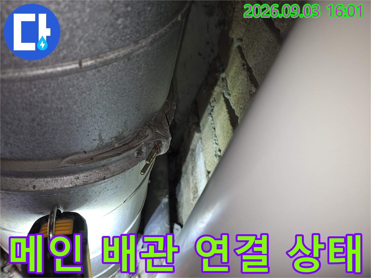 새로 신설된 메인 배관과 벽돌 사이의 접합부를 상세히 보여주는 이미지입니다.