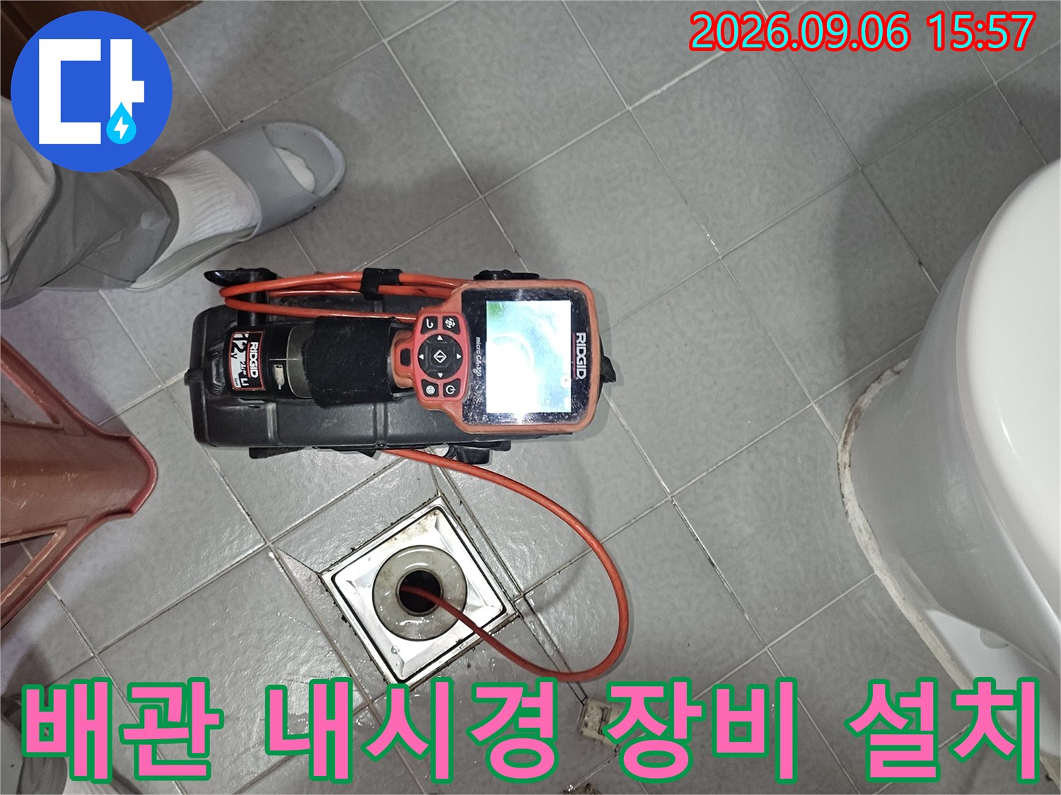 욕실 타일 바닥에-배관 검사용 내시경 장비를-세팅해둔 모습