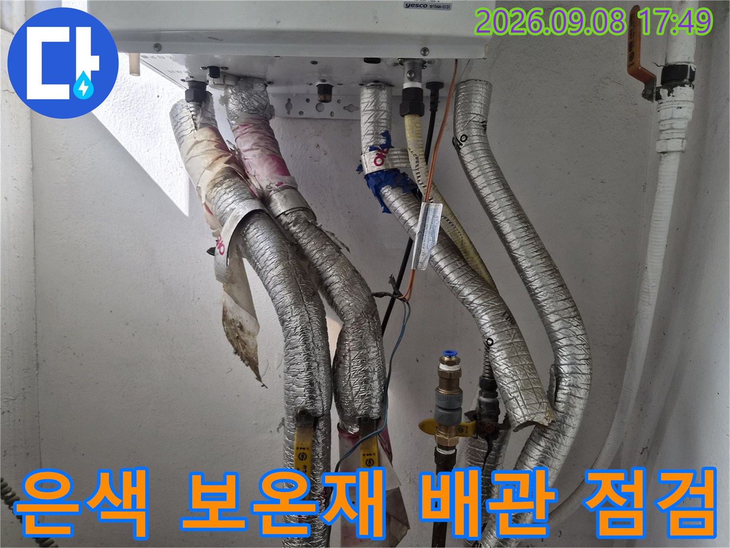 은색 보온재로 덮인 보일러 하단 배관들의 상세 모습-누수 지점 탐색 중